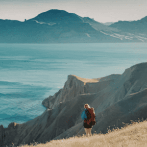 person standing on cliff overlooking mountains cinematic